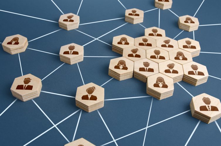 wooden hexagon-tiles with human drawings connected through white lines